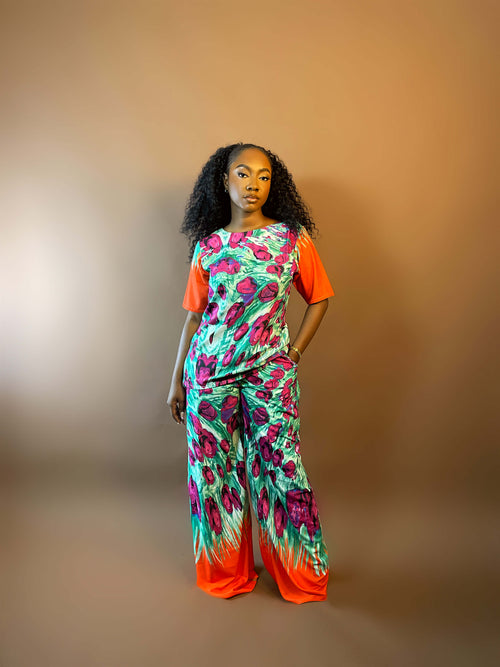 Woman wearing a colorful outfit with a gradient from orange to green on a brown background