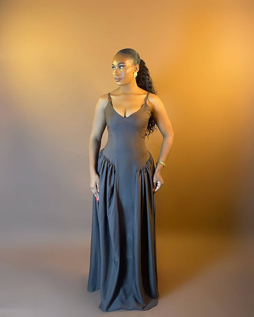 Woman wearing a gray dress against a gradient background