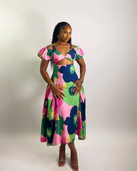 Woman wearing a colorful floral dress on a white background