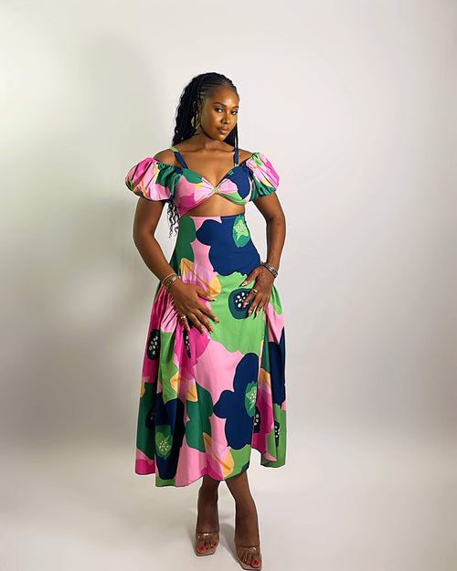 Woman wearing a colorful floral dress on a white background
